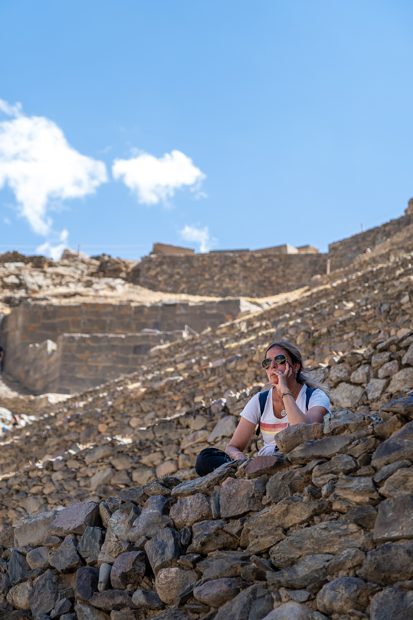 Woman sitting on some stones in an Inca ruin